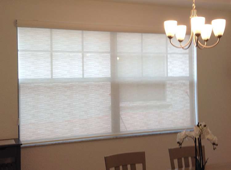 A dining room with two chairs and a table