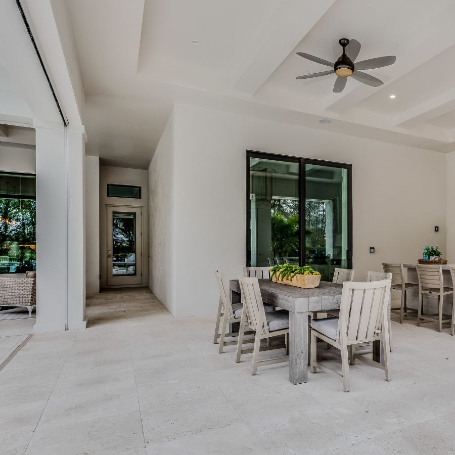 A table and chairs in the middle of an open floor plan.